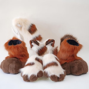 May include: A collection of furry cosplay accessories, including brown and white paw pads, ears, and boots. The boots have a dark blue interior and brown soles. The tail is white with brown spots.
