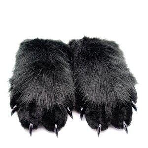 May include: A pair of black faux fur slippers with black claws. The slippers are soft and fluffy.