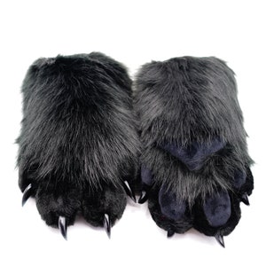 May include: A pair of black furry paw-shaped hand warmers with black claws.