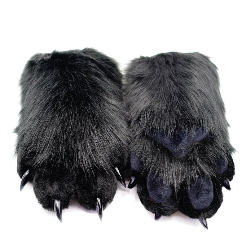 May include: A pair of black furry paw-shaped hand warmers with black claws.