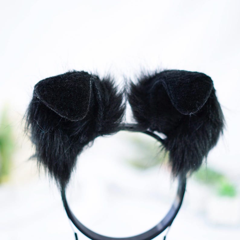 May include: Black furry cat ears headband. The headband is black and has two soft, black furry ears with black felt inside.