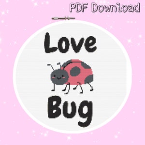 May include: A cross-stitch hoop featuring the words "Love Bug" above and below a cartoon ladybug. The ladybug is pink and black with a smiling face. The background is white, and the hoop is set against a pink background with the text "PDF Download".