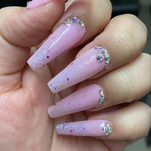 Baby pink confetti glitter ombre nails with rhinestone designs! Styled in long ballerina Choose almond, square, ballerina, coffin & stiletto
