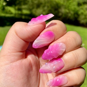 3D pink Jelly aura press on nails styled in medium Almond
