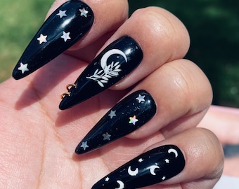 Moon child! Dark black star moon nails with accent hoop nail ! Styled in long stiletto!
