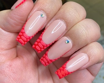 Hot pink croc French tip nails styled in medium ballerina