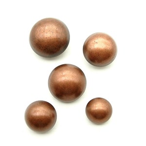 May include: Five round, copper-coloured buttons with a smooth, shiny finish.