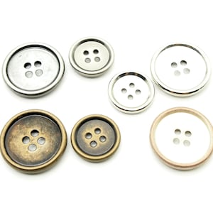 Peut inclure: Six boutons en métal de différentes tailles et finitions. Les boutons sont ronds avec quatre trous chacun et ont une finition argent, or et cuivre.