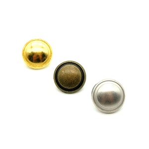 May include: Three round metal buttons in gold, bronze, and silver.