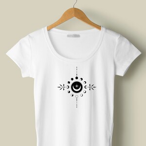 May include: White t-shirt with a black moon phases design. The design features a crescent moon with a star inside, surrounded by a circle of moon phases.
