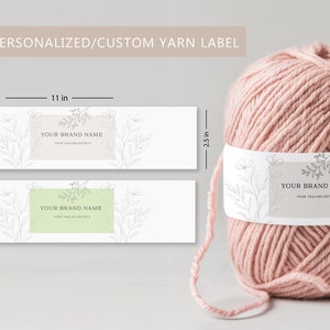 May include: A ball of pink yarn with a custom label. The label is 28 cm long and 6.4 cm high, with space for a brand name and details. The words "EDITABLE/PERSONALIZED/CUSTOM YARN LABEL" are at the top.