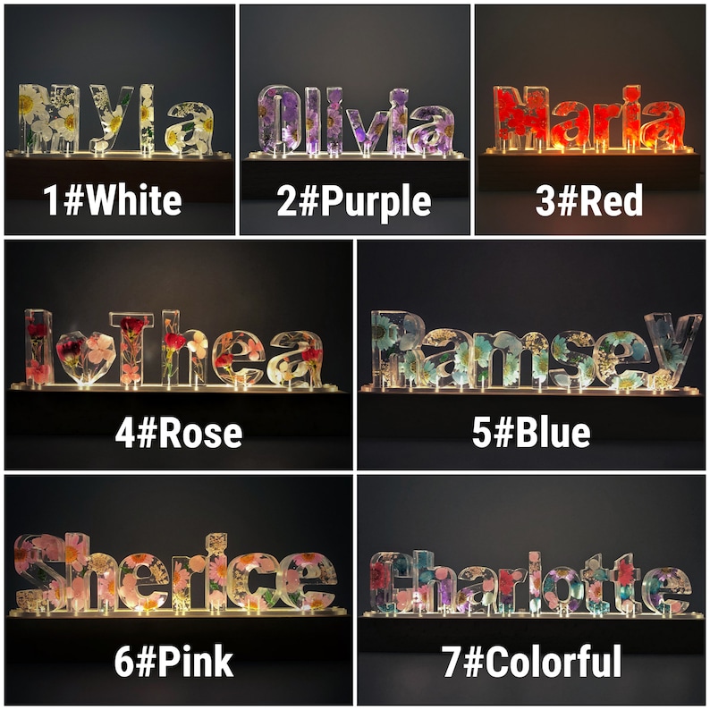 May include: Seven personalised name signs with embedded flowers and lights. The names are Myla, Olivia, Maria, Thea, Ramsey, Sherice, and Charlotte. The signs are numbered 1 through 7 and each has a colour theme: white, purple, red, rose, blue, pink, and colourful.