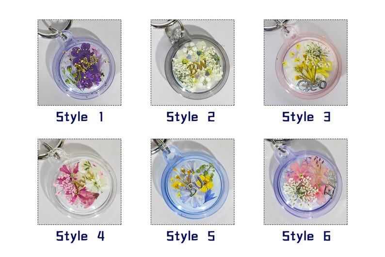 May include: A collection of six clear resin keychains, each with a different arrangement of dried flowers and decorative elements. Each keychain is labeled with a style number. The keychains have silver-colored key rings.