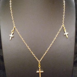 The Triple Cross Necklace.