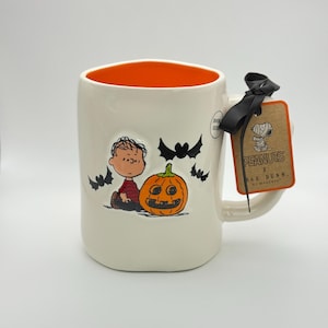 Peanuts Linus Halloween mug by Rae Dunn | Peanuts SPOOKY mug with Linus graphic sitting next to a jack o lantern | Great Peanuts gift