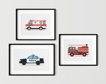 May include: Three framed illustrations of emergency vehicles. The top frame shows a white ambulance with a red cross and the word "AMBULANCE" on the side. The middle frame shows a blue and white police car with the word "POLICE" on the side. The bottom frame shows a red fire truck with a ladder and the words "FIRE DEPARTMENT" on the side.