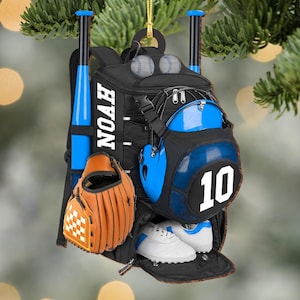 May include: A black baseball backpack ornament with a blue and white baseball helmet, a brown baseball glove, two white baseball shoes, and two baseballs. The backpack has the name "NOAH" and the number "10" on it.