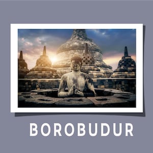 May include: A rectangular print featuring a stone Buddha statue centered in front of the Borobudur temple complex with bell-shaped stupas under a sunset sky. The word BOROBUDUR is printed in white capital letters below the image on a gray background.