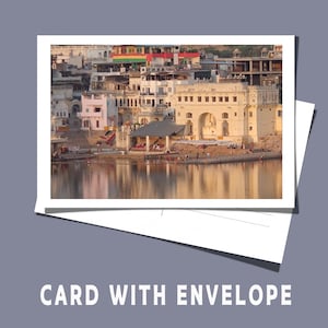 May include: A photograph of a scenic landscape featuring a body of water with buildings along the shore. The buildings are in shades of white and beige, with arched doorways and windows. The card is on top of a white envelope. The text "CARD WITH ENVELOPE" is at the bottom.