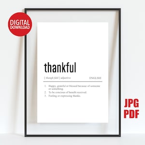May include: A framed print with the definition of the word "thankful" in black text on a white background. The definition includes the word's pronunciation and three numbered explanations. A red circle with "DIGITAL DOWNLOAD" is in the upper left.
