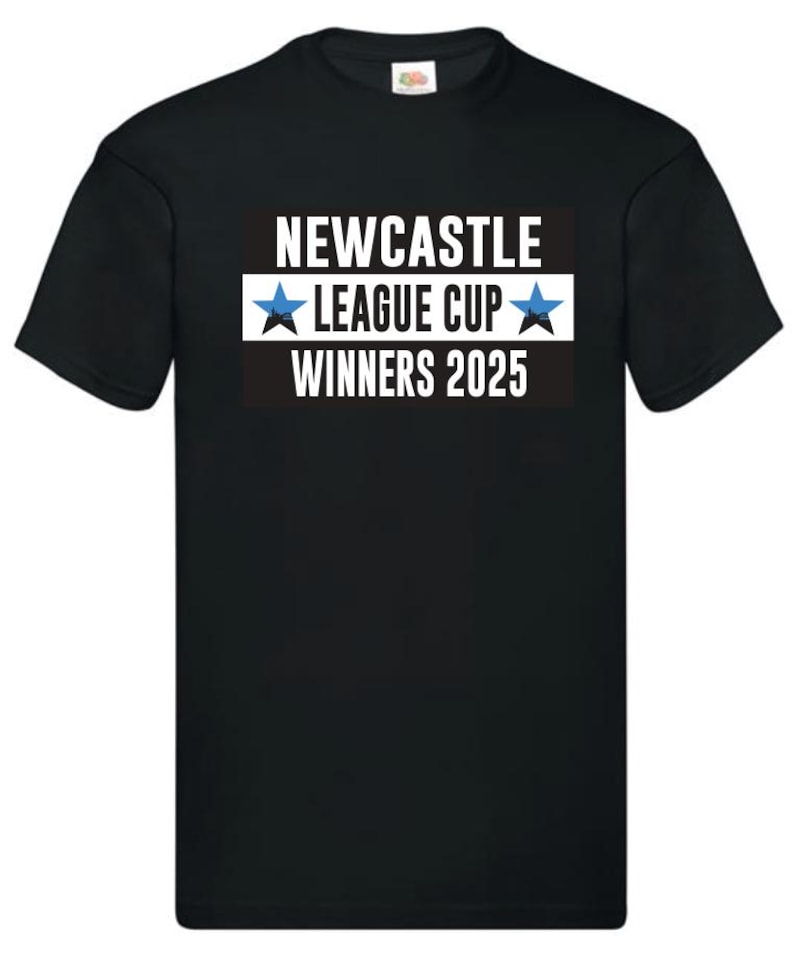 May include: Black t-shirt with the text "NEWCASTLE LEAGUE CUP WINNERS 2025" in white, with a blue star on each side of "LEAGUE CUP". The text is on a black and white rectangular background.