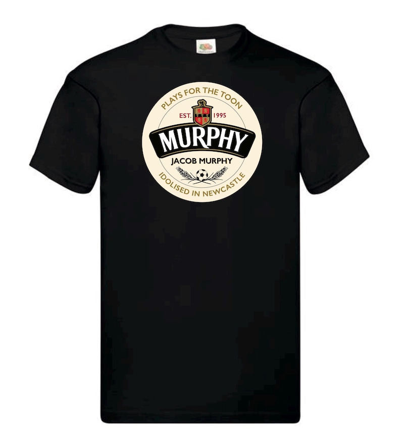 May include: Black t-shirt with a white circle graphic featuring the text "Murphy Jacob Murphy Plays for the Toon Est. 1995 Idolised in Newcastle".