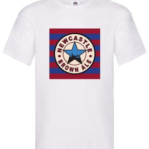May include: White t-shirt with a red, white, and blue striped background featuring a circular logo with the text "Newcastle Brown Ale" and a star.