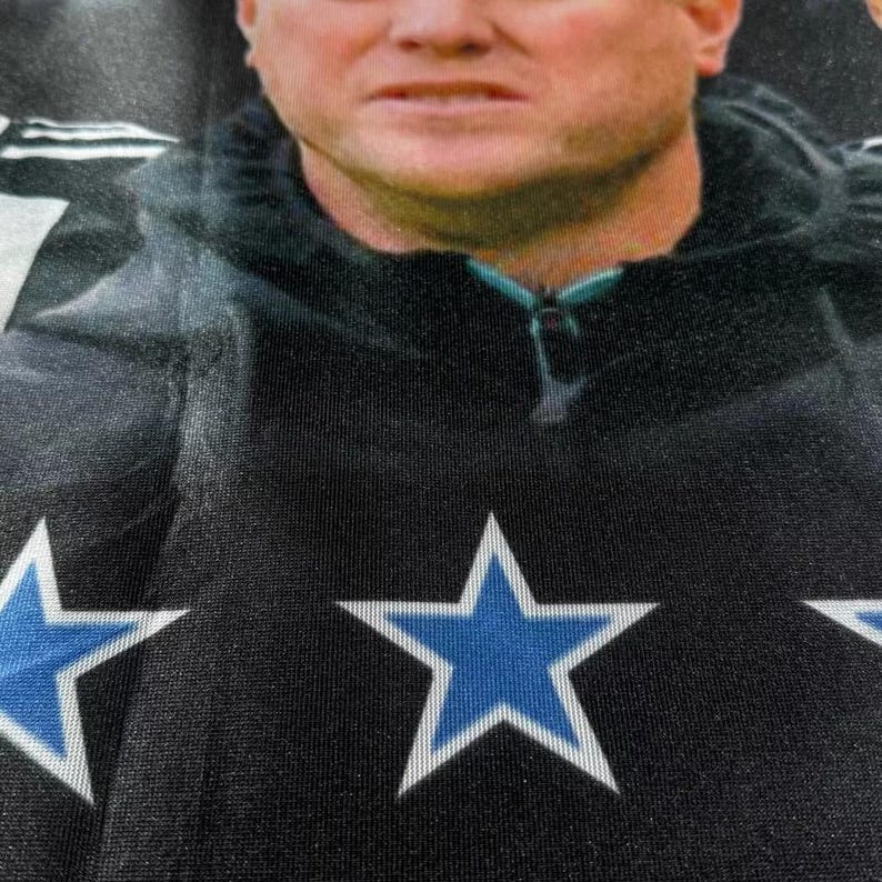 May include: Black fabric with two blue five-pointed stars.