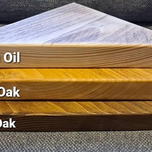 Reclaimed scaffold board corner shelf: three chunky wedge-shaped planks in Danish Oil, Light Oak, Dark Oak.