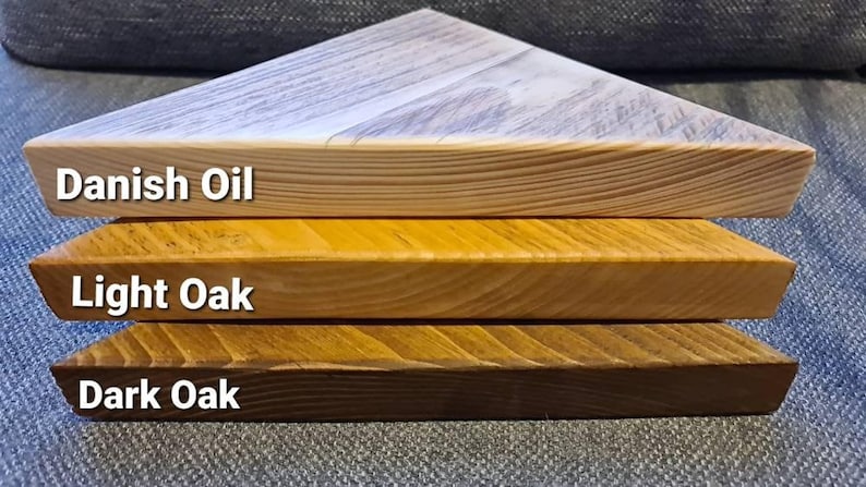 Reclaimed scaffold board corner shelf: three chunky wedge-shaped planks in Danish Oil, Light Oak, Dark Oak.