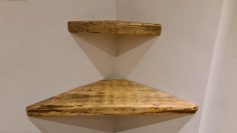 Pair of reclaimed scaffold board corner shelves, rustic industrial floating triangles for plants in a farmhouse-style corner.