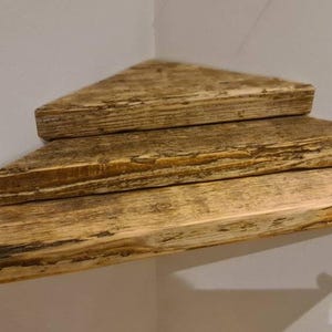 Reclaimed scaffold board corner shelf, chunky rustic industrial floating shelf for houseplants in a corner.
