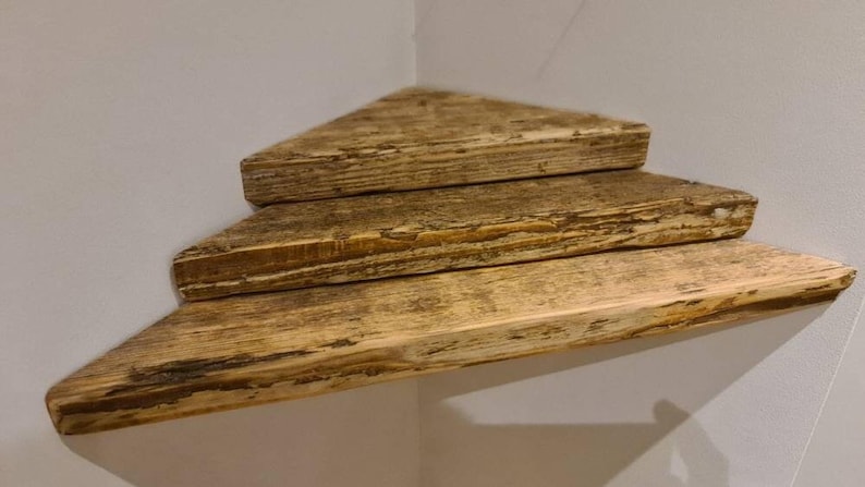 Reclaimed scaffold board corner shelf, chunky rustic industrial floating shelf for houseplants in a corner.