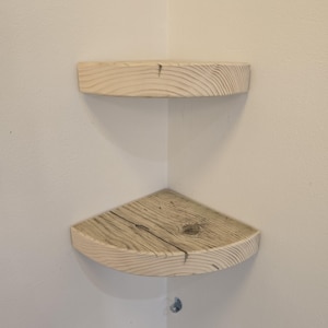 Reclaimed wood corner shelf set: three rustic round-corner scaffold-board shelves in a corner, ideal for plants.