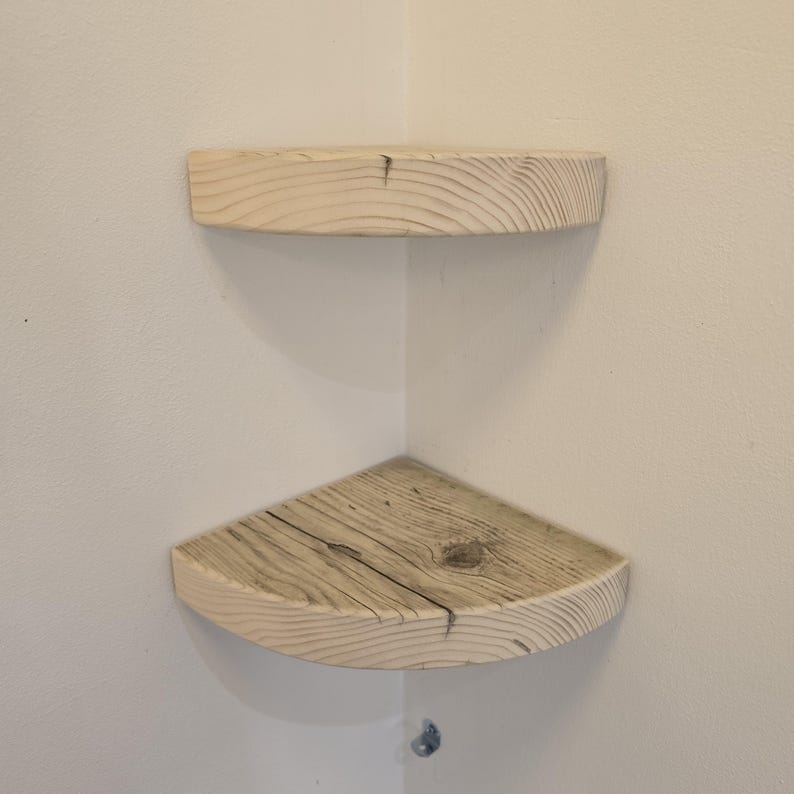 Reclaimed wood corner shelf set: three rustic round-corner scaffold-board shelves in a corner, ideal for plants.