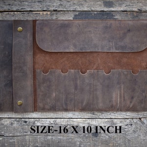 May include: Brown leather roll-up tool holder with six slots and a flap closure. The roll measures 16 x 10 inches.
