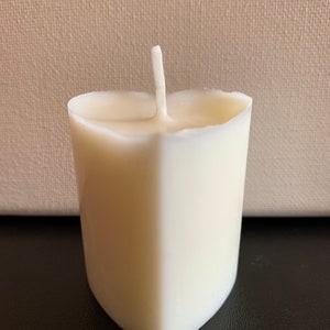 May include: A white heart-shaped candle with a single wick.