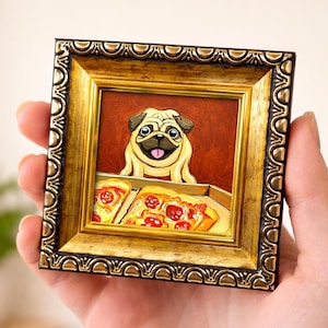 May include: A framed painting featuring a pug dog with a pizza. The artwork is in a gold ornate frame. The pug is light tan with a black muzzle and is looking at the pizza. The pizza has red pepperoni and yellow cheese.