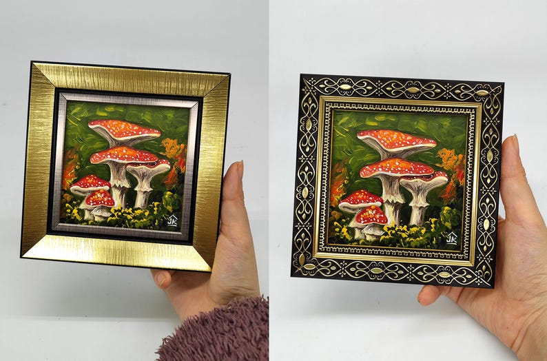 May include: A framed painting of red and white mushrooms with white spots on a green background. The frame is gold with a silver inner border.