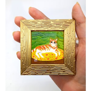 Orange Cat Framed Painting: Funny Ginger Cat on Yellow Blanket