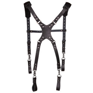 May include: Black leather camera strap with adjustable straps and metal hardware.