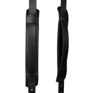 May include: Two black leather camera straps with adjustable buckles. One strap has a padded handle.