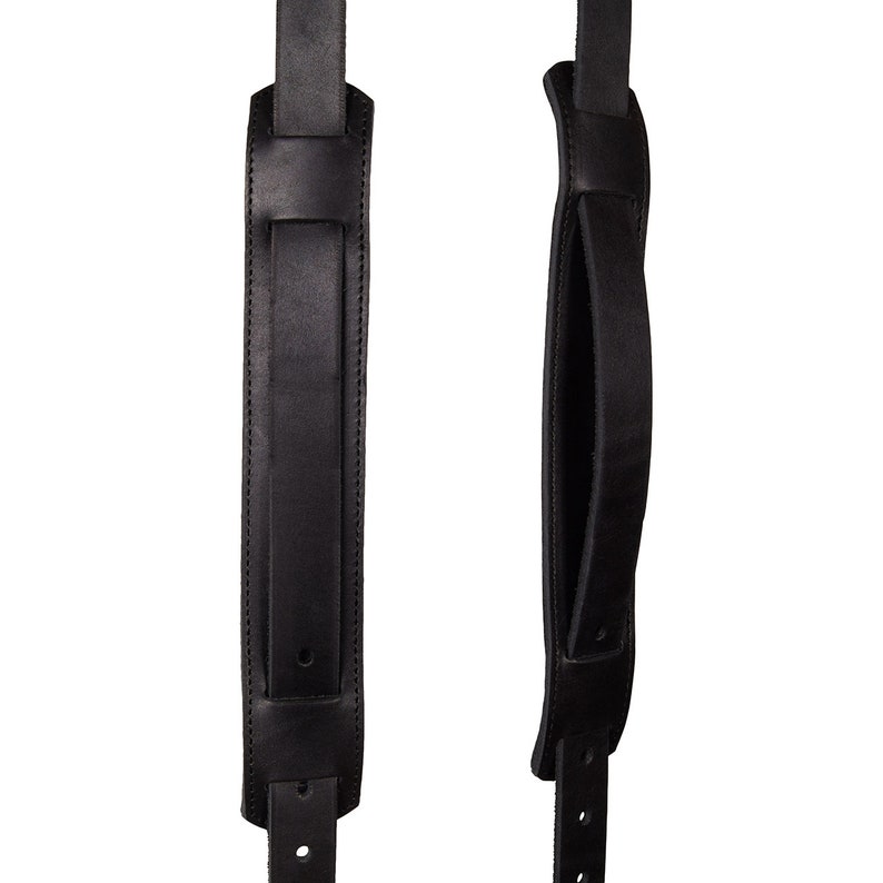 May include: Two black leather camera straps with adjustable buckles. One strap has a padded handle.