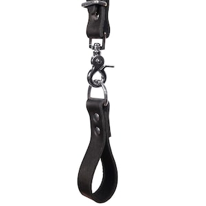 May include: A black leather camera strap with a metal loop and a hand strap.