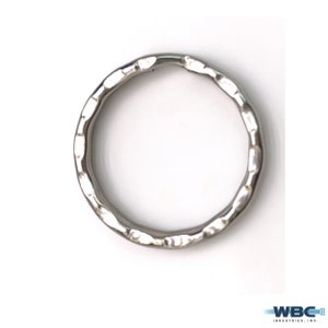 May include: A silver metal key ring with a textured finish.