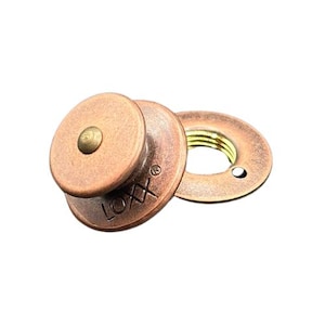 May include: A set of copper-colored LOXX fasteners. The set includes a round, domed stud with a small brass-colored rivet and a matching washer. The word "LOXX" is stamped on the stud.