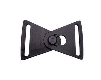 May include: Black plastic buckle with a triangular shape and a small round hole in the center. The buckle is designed to be used with a strap or belt.