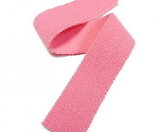 May include: Pink fuzzy fabric trim with a zig-zag edge. The trim is made by VELCRO.