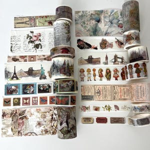 May include: A collection of decorative washi tapes with various designs. The tapes feature images of landmarks, flowers, butterflies, and vintage ephemera. The color palette includes shades of brown, beige, and pastel colors, perfect for scrapbooking and crafting projects.