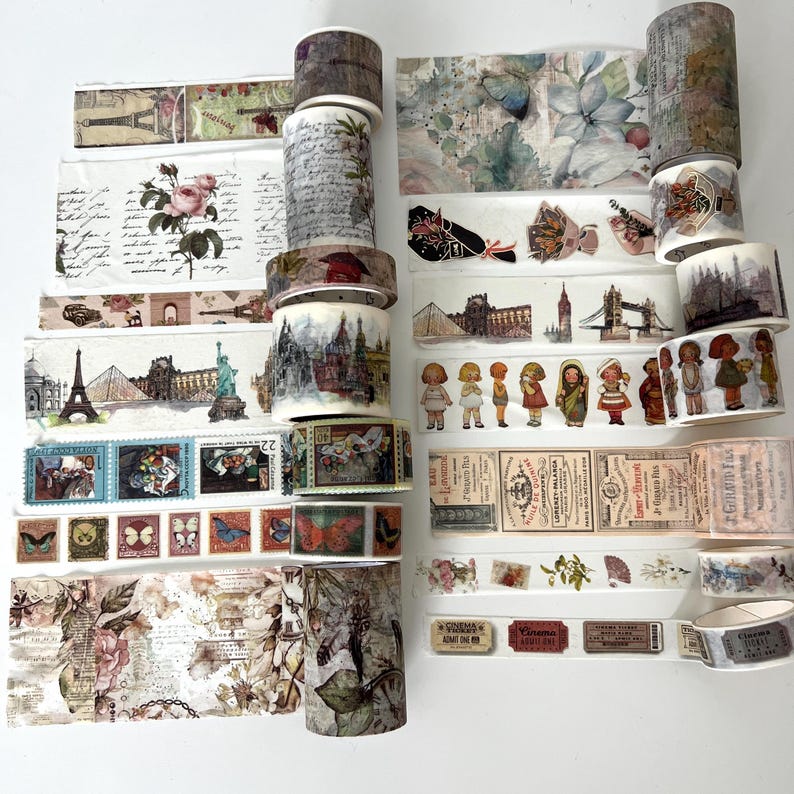 May include: A collection of decorative washi tapes with various designs. The tapes feature images of landmarks, flowers, butterflies, and vintage ephemera. The color palette includes shades of brown, beige, and pastel colors, perfect for scrapbooking and crafting projects.